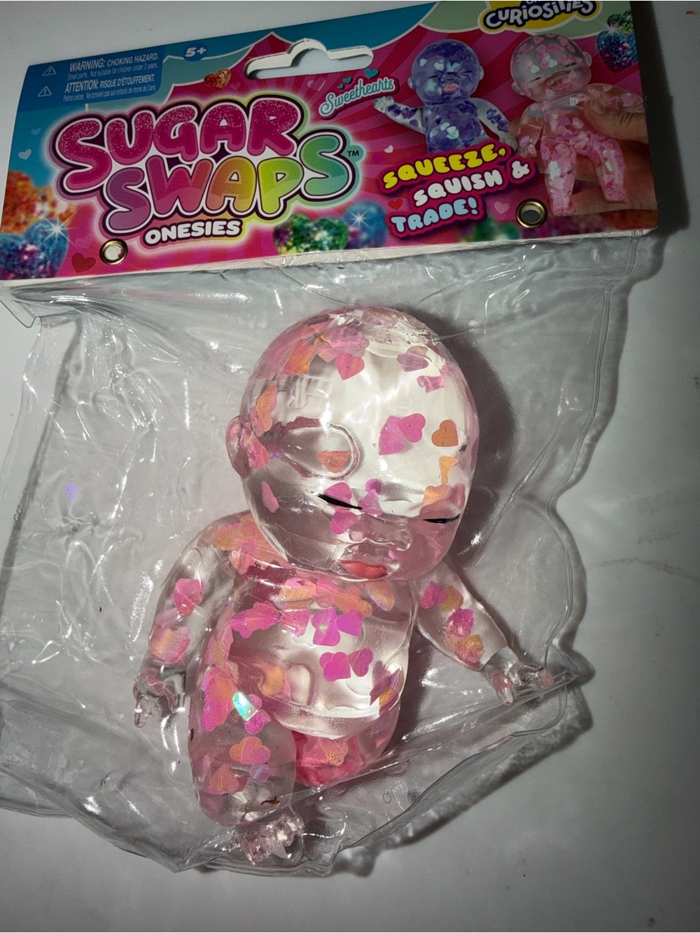 RMS Beauty Clear Squeeze Baby Doll with Pink and Orange Hearts